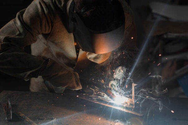 Manufacture Worker Welding Metal With Sparks at Factory